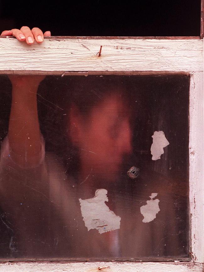 Daughter Karen Williams is pictured behind the bedroom window of the Balmain home where her mother Pauline Gillard was shot. File picture