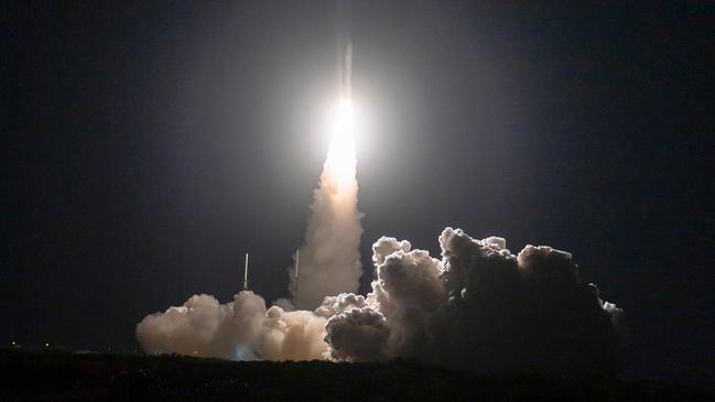 The rocket carrying bits of Star Trek inventor Gene Roddenberry, right, blasts off. Picture: AFP