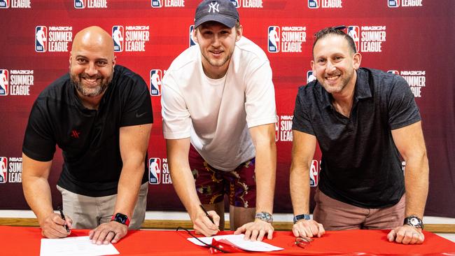 Houston Rockets general manager Rafael Stone, Aussie centre Jock Landale and agent Sammy Wloszczowski are all smiles as the Boomer inks a four-year deal with the NBA club. Picture: Supplied