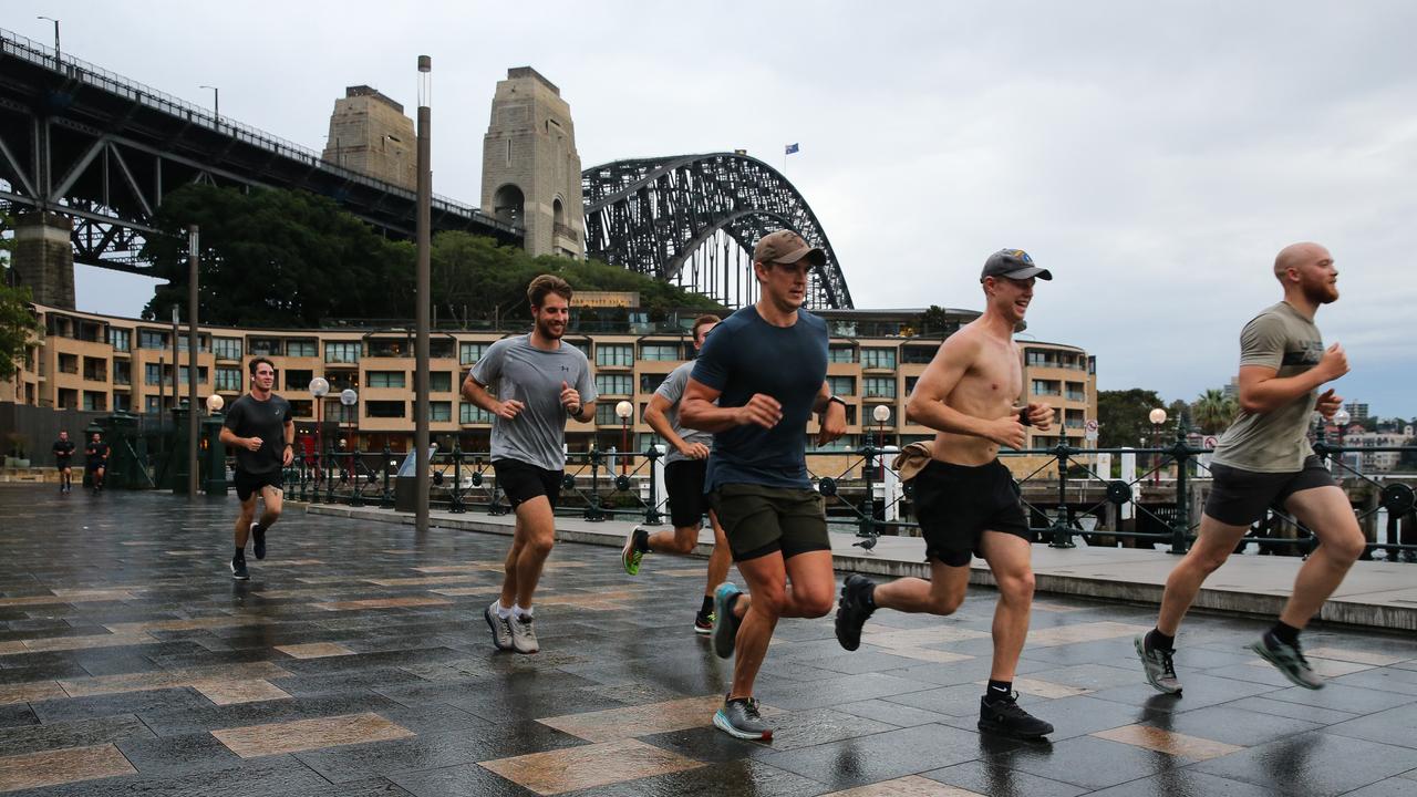 Runners try not to slip on wet footpaths. Picture: NCA NewsWire / Gaye Gerard