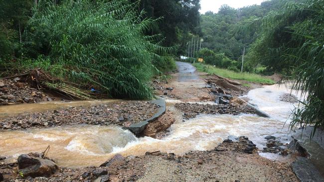 Ophir Glen Road appears more like a creek after flooding.