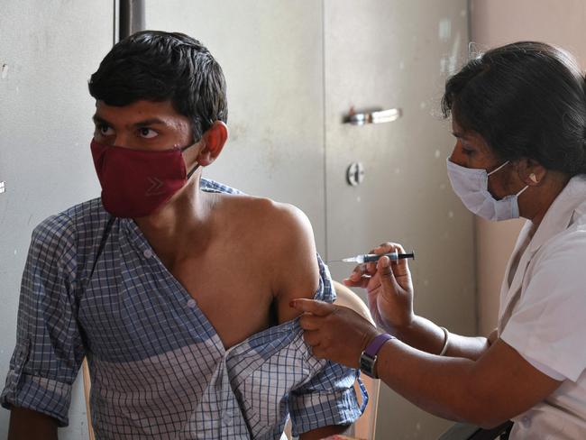 A health worker inoculates a college student with a dose of Covaxin vaccine against Covid-19 in Bangalore. Picture: Manjunath Kiran / AFP