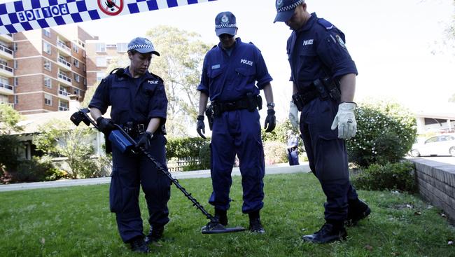 At 6.25pm on September 3, 2009, McGurk, 44, was shot dead. Police search the area around his Cremorne home.