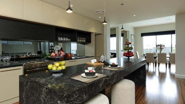 The stylish kitchen with mirrored splashback is a natural extension of the open-plan living room.