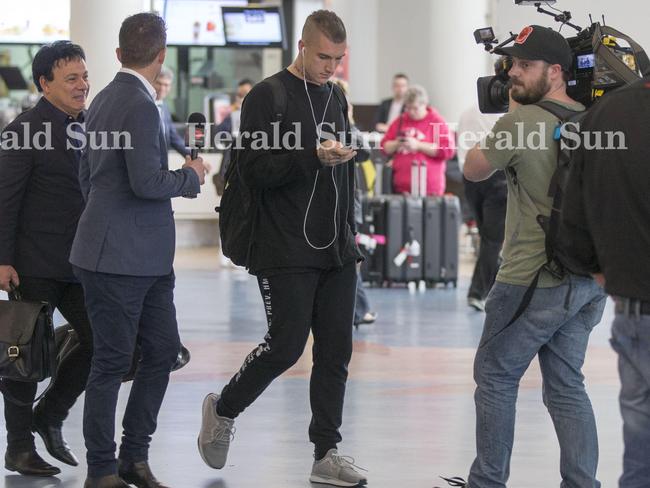 Dustin Martin arrives at Auckland Airport with his manager today