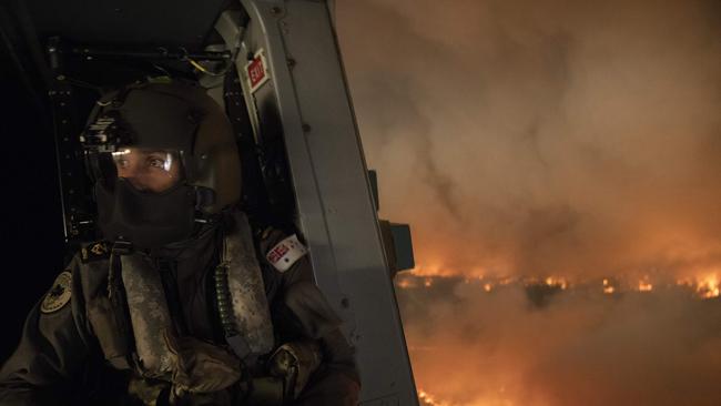 An ADF aircrewman monitors the Tianjara fire, south of Sydney