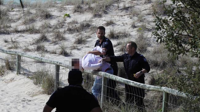 Police chase and arrest a runner from Gold Coast Airport at Coolangatta on Monday. Picture: Glenn Hampson