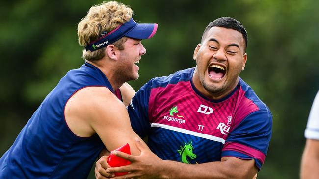 Smiling Reds weapon Taniela Tupou (right) during training warm-ups with Angus Scott-Young at Ballymore. Picture: Stu Walmsley