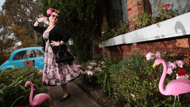 Ms Andreassen admires the pink flamingoes in her front garden.