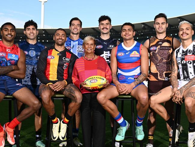 MELBOURNE, AUSTRALIA - MAY 13:  (Back Row L-R) Jayden Davey of the Bombers, Tyson Stengle of the Cats, Jy Simpkin of the Kangaroos, Zac Williams of the Blues, Karl Amon of the Hawks, Rhyan Mansell of the Tigers, (Front Row L-R) Kysaiah Pickett of the Demons, Bradley Hill of the Saints, Aunty Pam Pedersen, Yorta Yorta Elder and daughter of Sir Doug Nicholls, Jamarra Ugle-Hagan of the Bulldogs and Bobby Hill of the Magpies pose for a photo during the 2024 Sir Doug Nicholls Round Launch at Melbourne Cricket Ground on May 13, 2024 in Melbourne, Australia. (Photo by Quinn Rooney/Getty Images)