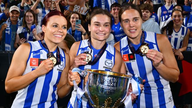 MELBOURNE, AUSTRALIA - NOVEMBER 30: Jenna Bruton, Ash Riddell and Jasmine Garner of the Kangaroos celebrate during the AFLW Grand Final match between North Melbourne Tasmanian Kangaroos and Brisbane Lions at Ikon Park, on November 30, 2024, in Melbourne, Australia. (Photo by Quinn Rooney/Getty Images)