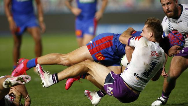 Ryan Papenhuyzen stops a near certain try from Kalyn Ponga. Picture: AAP.