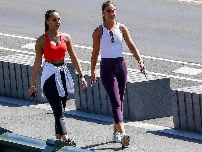 MELBOURNE , AUSTRALIA - NewsWire Photos FEBRUARY 17, 2021 : Two women walking across Princes Bridge on MelbourneÃs last day of a five day lockdown following a hotel quarantine Covid-19 leak at the Holiday Inn, Melbourne Airport. Picture : NCA NewsWire  /  Ian Currie