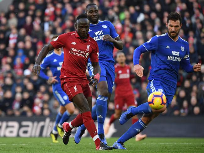 Liverpool's Senegalese striker Sadio Mane (L) scores their fourth goal during the English Premier League football match between Liverpool and Cardiff City at Anfield in Liverpool, north west England on October 27, 2018. (Photo by Paul ELLIS / AFP) / RESTRICTED TO EDITORIAL USE. No use with unauthorized audio, video, data, fixture lists, club/league logos or 'live' services. Online in-match use limited to 120 images. An additional 40 images may be used in extra time. No video emulation. Social media in-match use limited to 120 images. An additional 40 images may be used in extra time. No use in betting publications, games or single club/league/player publications. /