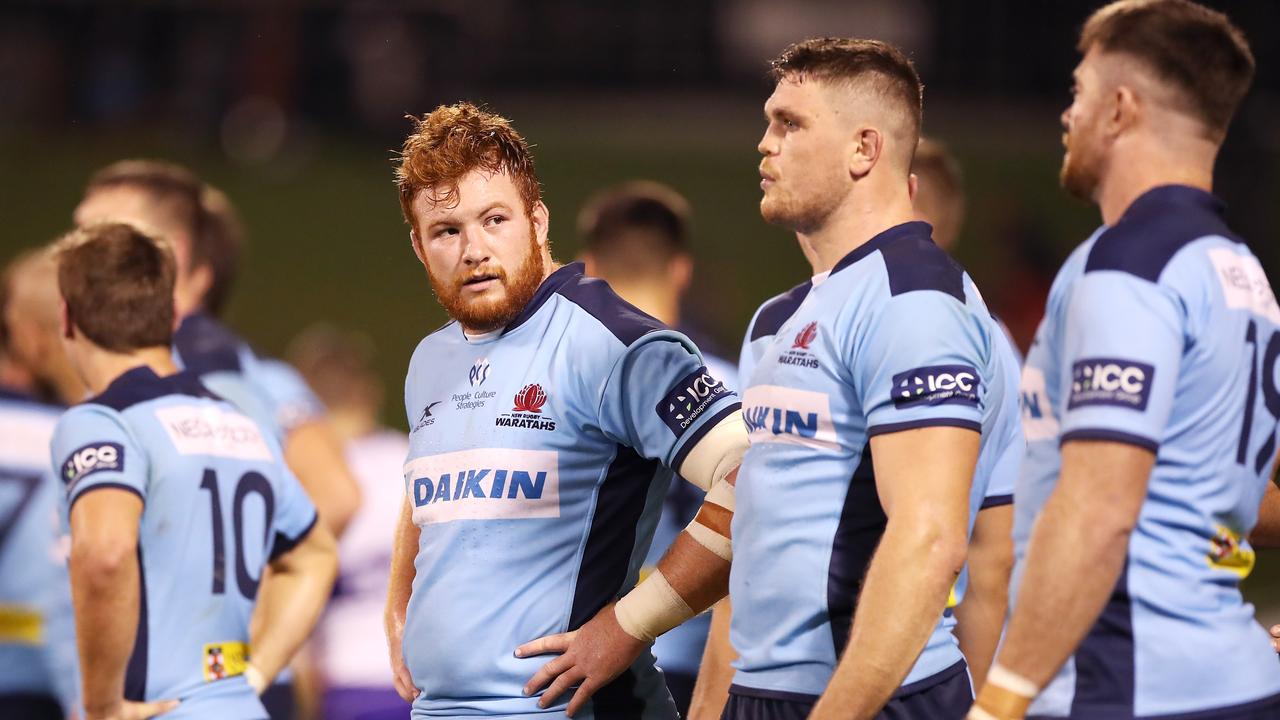 Harry Johnson-Holmes of the Waratahs and his team look dejected after a Chiefs try.