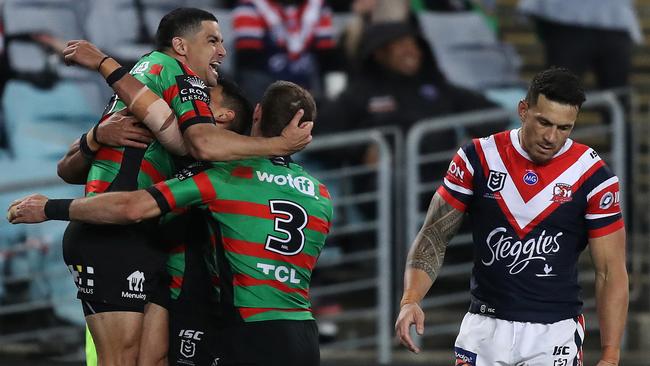 Cody Walker celebrates a try as star Rooster Sonny Bill Williams looks dejected. Picture: Brett Costello