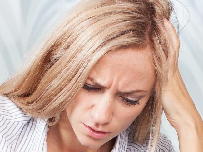 Sad woman looks at the bill. Female working at home