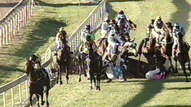 Racing at Ipswich. A wall of fallen horses and jockeys block the Ipswich track after Mushtak crashes. a/ct. 1 July 2000 /racing