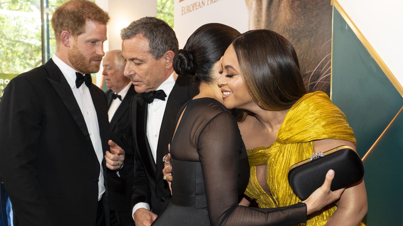 Prince Harry chats with Disney CEO Robert Iger as Meghan embraces Beyonce Knowles-Carter. Picture: Niklas Halle'n-WPA Pool/Getty Images