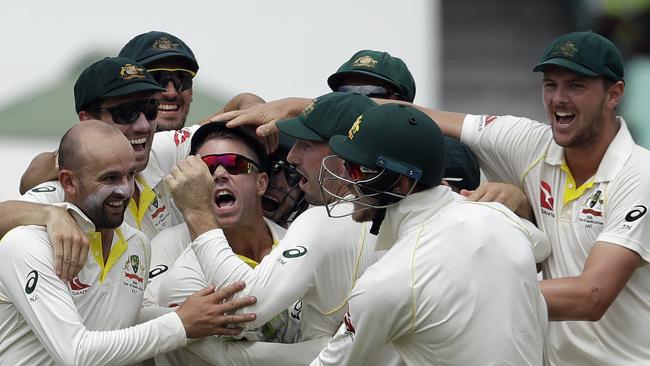 Nathan Lyon and David Warner celebrate after running out AB de Villiers.