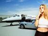 Portrait of young woman smoking cigarette with car and airplane in the background