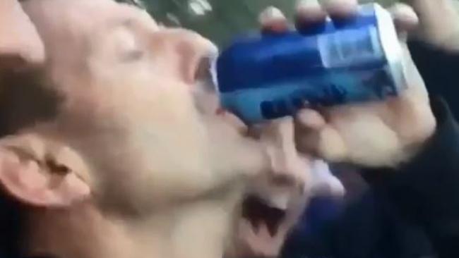 Former Australian prime minister Tony Abbott skolling a beer at Manly Oval.