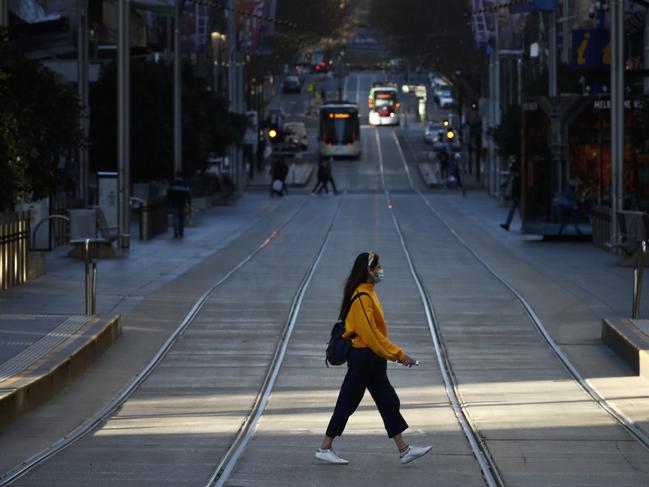 A woman walks through a desolate Bourke Street during the second Melbourne lockdown. Picture: NCA NewsWire / Daniel Pockett