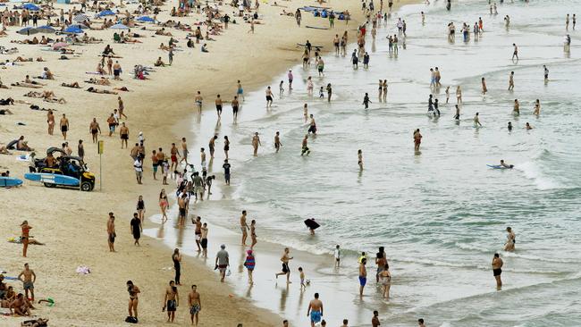 Sydneysiders and tourists alike beat the heat on Bondi Beach. Picture: John Appleyard