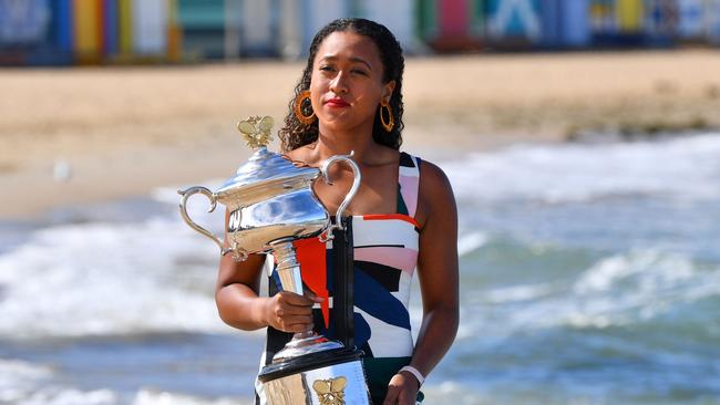 Naomi Osaka soaks up the spoils of her Australian Open triumph at Brighton beach.