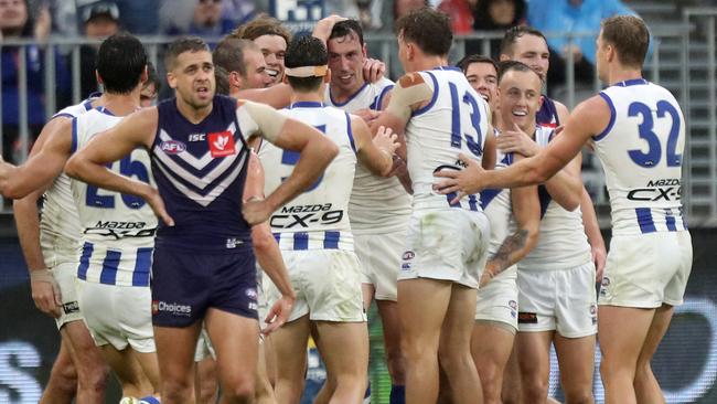 Todd Goldstein is mobbed after kicking a goal in his 200th game.