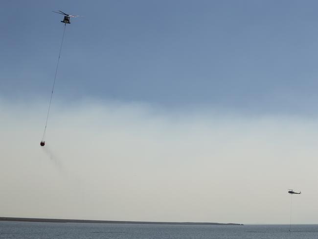 A wall of smoke obscures the view of water-bombing aircraft tackling the Miena blaze. Picture: Heath Holden/Getty