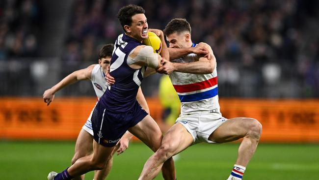 Bulldogs star Josh Dunkley tackles Heath Chapman. Picture: Daniel Carson/AFL Photos