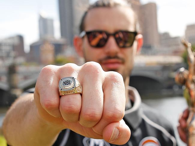 MELBOURNE, AUSTRALIA - APRIL 01:  Melbourne United captain Chris Goulding  poses with the trophy and his championship ring after winning the NBL Grand Championship during a Melbourne United media opportunity after their NBL Grand Final win, at The Boat Sheds on April 1, 2018 in Melbourne, Australia.  (Photo by Scott Barbour/Getty Images)