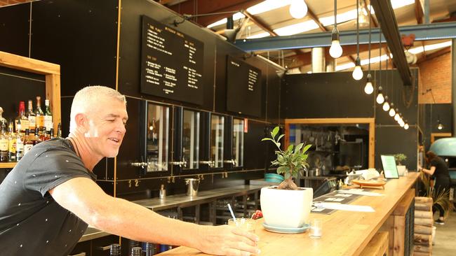 Owner Michael Olsen serves a drink at his new venue. Picture: Hamish Blair