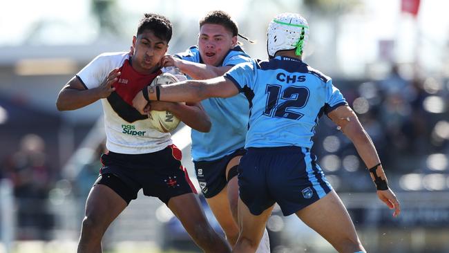 NSW CIS's Ashton Large is tackled during the under 15 ASSRL schoolboy rugby league championship grand final last year.