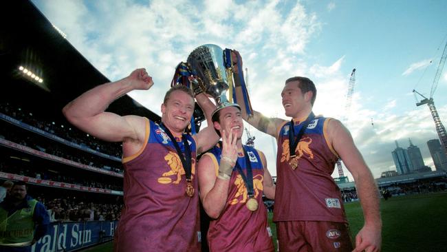 Michael Voss, Craig McRae and Justin Leppitsch with the 2003 premiership cup.