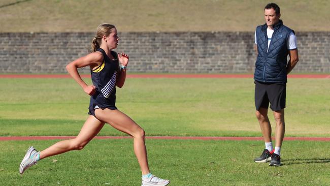 Claudia Hollingsworth trains while her coach Craig Mottram watches on. Picture: Alex Coppel