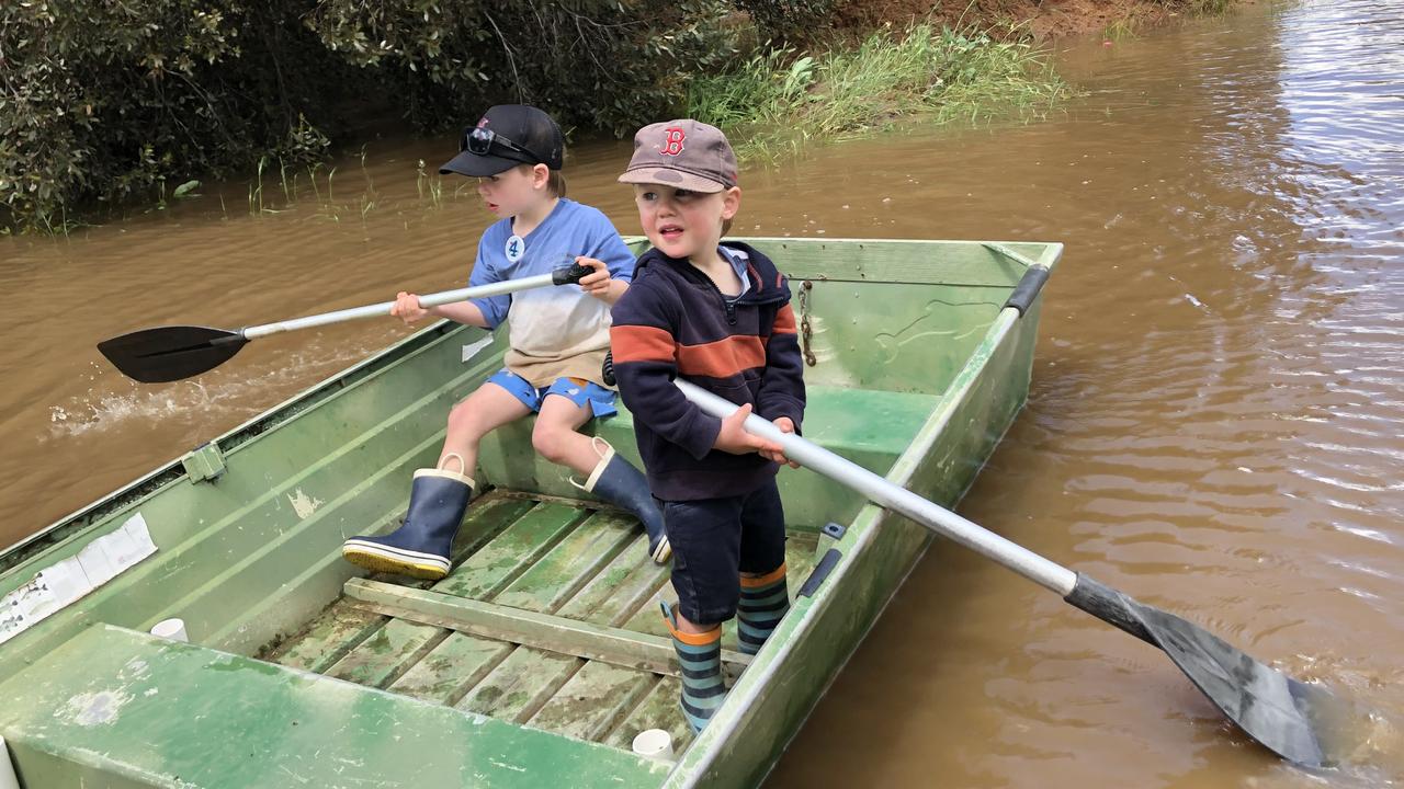 Billy and Tom Hare in their neighbour’s flooded yard on Simmie Rd, Echuca Village. Picture: Julieanne Strachan