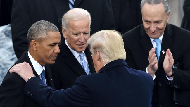 US President Donald Trump speaks with former President Barack Obama and former Vice President Joe Biden during his inauguration ceremony at the US Capitol in Washington, DC in 2016. Picture: AFP