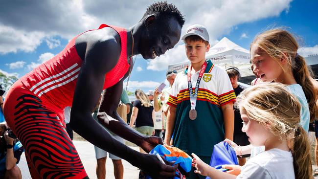 Australia's Gout Gout signs autographs after competing in the men's 200m heats.