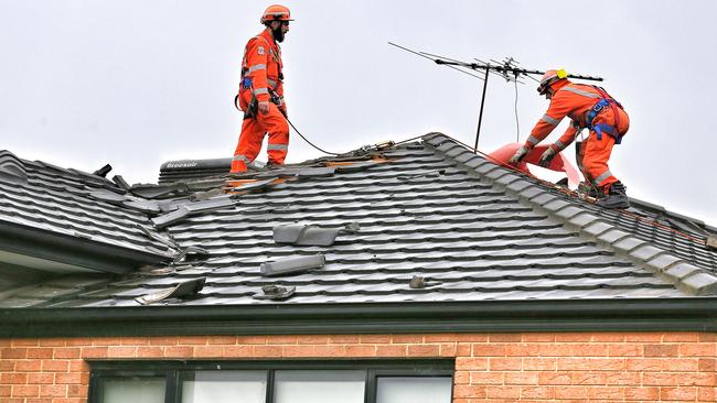 SES crews work on a damaged roof in Truganina. Picture: Tim Carrafa