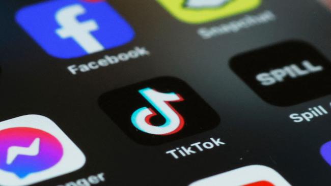 (FILES)  In this photo illustration, the TikTok app is seen on a phone on March 13, 2024 in New York City. TikTok sharply denounced the passage on April 20, 2024,  by the US House of Representatives of a bill that threatens to ban the popular social-media platform unless it severs its ties to Beijing. (Photo by Michael M. Santiago / GETTY IMAGES NORTH AMERICA / AFP)