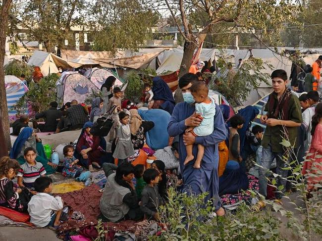 Internally displaced Afghan families, who fled from Kunduz, Takhar and Baghlan province due to battles between Taliban and Afghan security forces, sit in front of their temporary tents at Sara-e-Shamali in Kabul in August. Picture: Wakil Kohsar/AFP/Getty Images