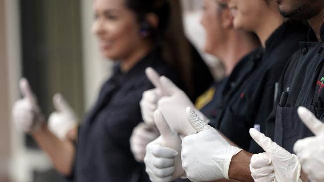 Employees at a Lupe Tortilla restaurant in Texas wear gloves. Picture: AP