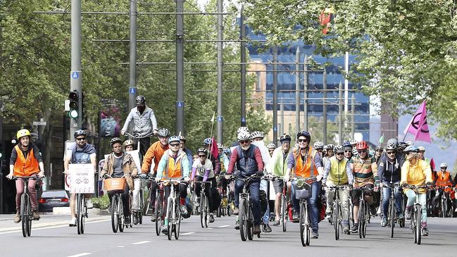 Extinction Rebellion protesters ride down King William Road. Picture: Sarah Reed