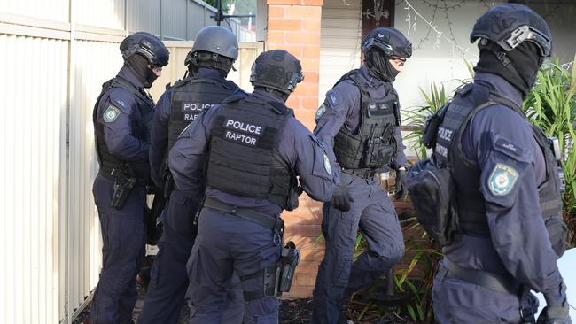 Raptor Squad officers swarmed onto the Merrylands property. Picture: Rohan Kelly