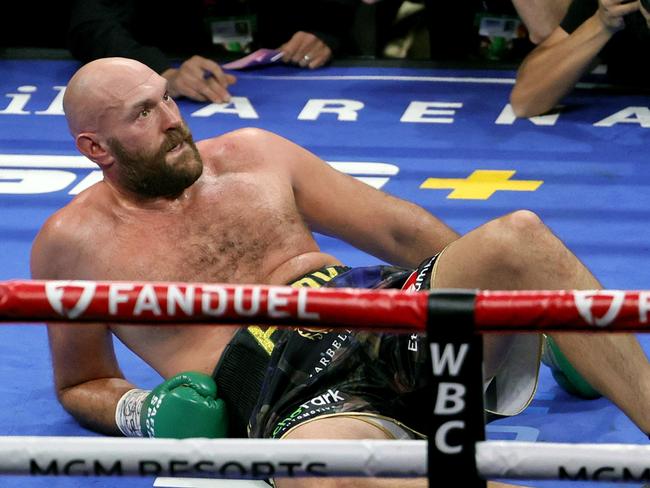 LAS VEGAS, NEVADA - OCTOBER 09: Tyson Fury reacts after he was knocked down by Deontay Wilder in the fourth round of their WBC heavyweight title fight at T-Mobile Arena on October 9, 2021 in Las Vegas, Nevada. Fury retained his title with an 11th-round knockout. Fury retained his title with an 11th-round knockout.   Ethan Miller/Getty Images/AFP == FOR NEWSPAPERS, INTERNET, TELCOS & TELEVISION USE ONLY ==