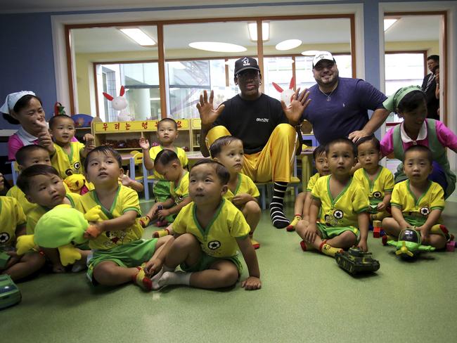 Dennis Rodman sits with children from the Pyongyang orphanage and nursery. Picture: AP Photo/Kim Kwang Hyon
