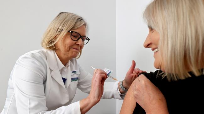 Adelaide pharmacist Robyns Johns gives Sue Fishlock her second dose of the AstraZeneca vaccine. Picture: Kelly Barnes