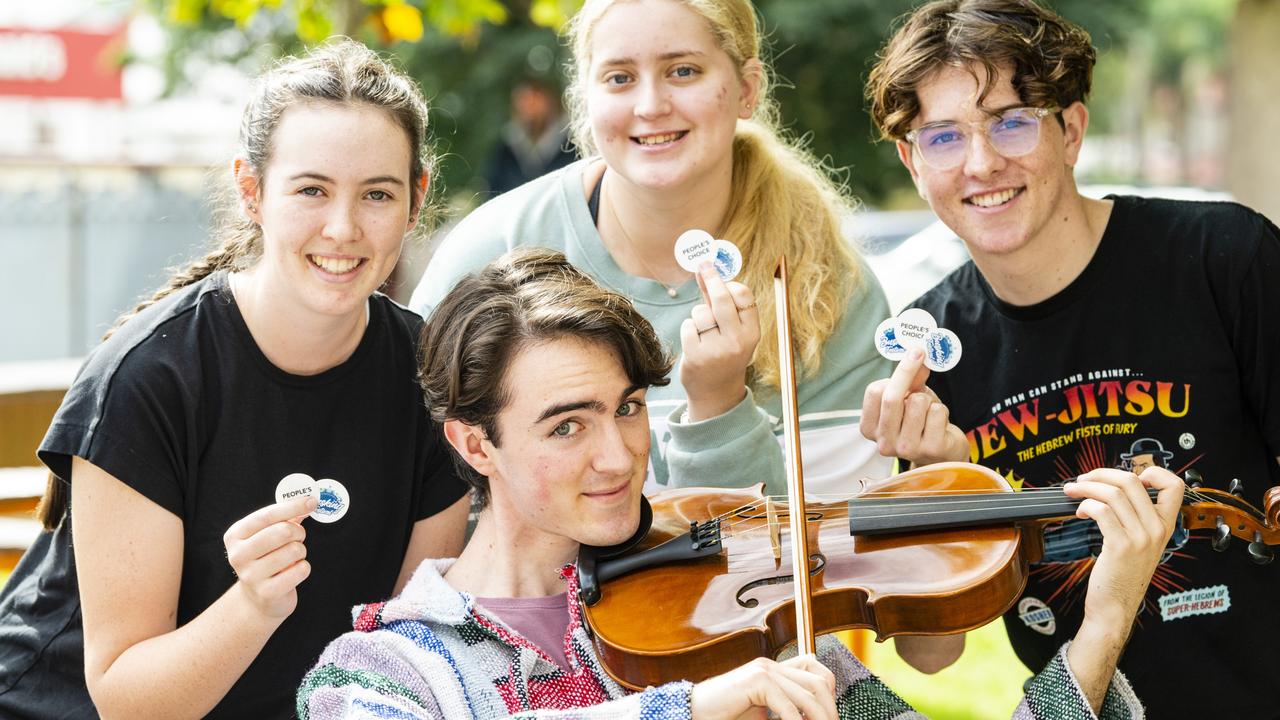 A Mate's Banjo member Joe Watson gets support from friends (back, from left) Amelia Condon, Kaylee Keehn and Riley Furse in the Toowoomba Busking Festival, Saturday, April 30, 2022. Picture: Kevin Farmer